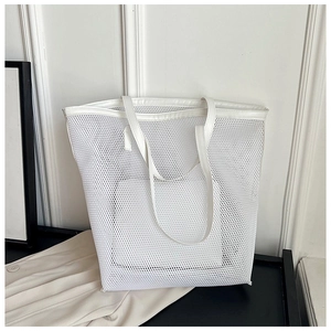 Detail view of a white mesh tote bag with breathable PVC texture for beach and daily use