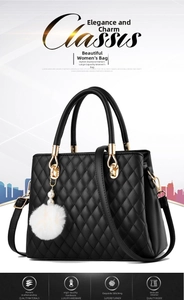 Close-up of black quilted leather handbag with gold metal hardware and pearl charm