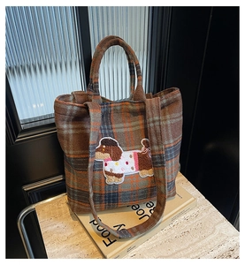 Close-up of brown plaid wool tote bag featuring a cute 3D sausage dog embroidery detail