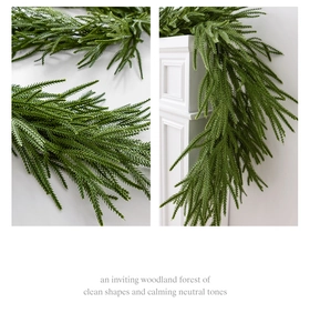 Detail of Norfolk pine garland with lush green needles draped over a white fireplace