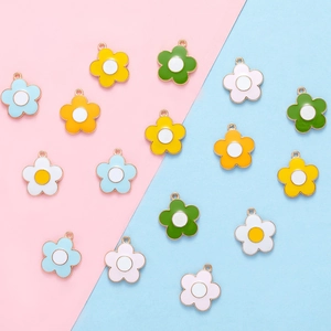 Detail of colorful five-petal flower alloy charms in yellow, green, pink and blue shades