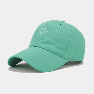 Detail view of mint green baseball cap with white sun embroidery and precise stitching