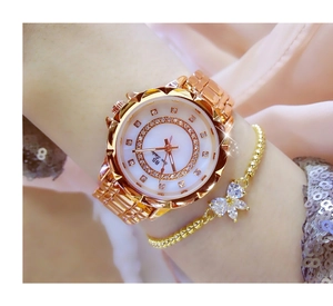 Close-up of rose gold women's watch with rhinestone bezel and mother of pearl dial detail