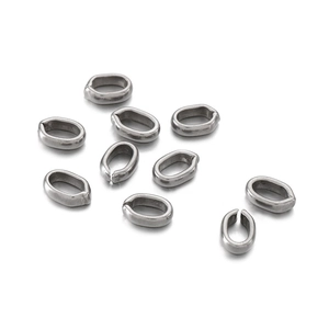 Close-up of silver oval split rings and connectors for jewelry making on white background