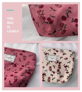 Detail of floral corduroy makeup bag with textured fabric and vintage label stitching