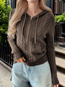 Detailed view of brown cable knit texture and zipper on this long sleeve hooded cardigan