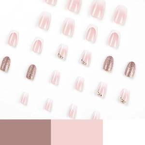 French tip press-on nails with pink gradient, rhinestones, and rose gold glitter accents