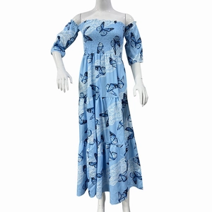 Macro detail of a light blue off-shoulder dress featuring layered ruffles and butterfly print