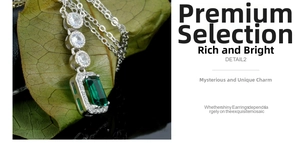 Close-up of rectangular emerald pendant with halo zircon settings on a green leaf