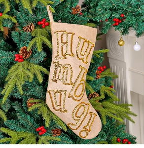 Close-up of burlap Christmas stocking with gold sequin embroidery and HUMBUG text