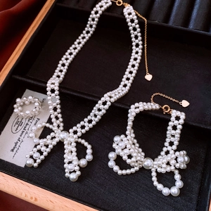 Detail of pearl jewelry set with bow tie design in a velvet box for a vintage look