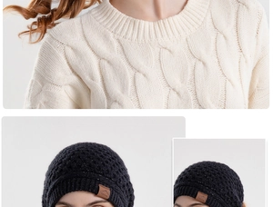 Detail of cable knit sweater collar and black knit beanie with Sport leather patch