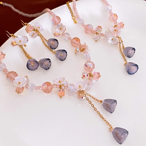 Elegant beaded earrings with acrylic lily of the valley and purple crystal accents