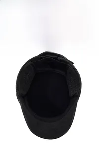 Detail view of winter flat cap for elderly men with ear flaps and thick lining
