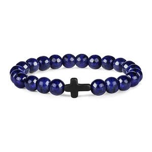 Macro shot of polished blue stone beads and a black cross charm on a men's beaded bracelet