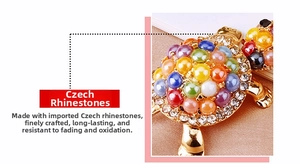 Close-up of colorful Czech rhinestones and polished gold plating on turtle keychain