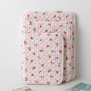 Three-piece quilted laptop sleeve set with pink plaid and red cherry floral patterns