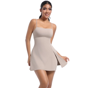 Detail view of beige athletic mini dress featuring slim straps and side slit design