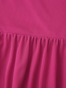 Detailed macro view of magenta pleated mesh fabric showing fine texture and drapery