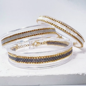 Detailed view of woven Miyuki bead bracelets with gold lobster clasp and extension chain
