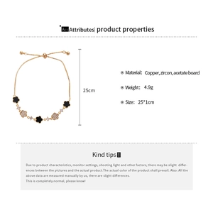 Detail view of acetate flower bracelet with zircon stones and adjustable pull chain