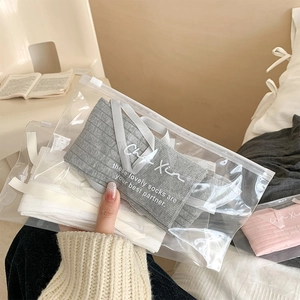 Close-up of ribbed knit socks in grey white and pink with matte zipper packaging bags
