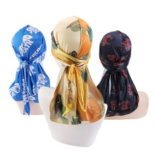 Detailed view of satin durags in blue, floral and red patterns on white mannequins