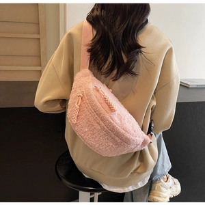 Detailed back view of a pink plush crossbody bag with a woven zipper pull for casual wear