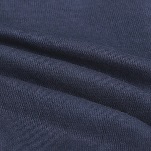Macro detail of high-quality navy blue knitted fabric texture showing soft weave patterns
