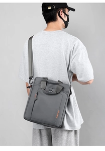 Detailed view of gray nylon crossbody briefcase with adjustable strap and top handle