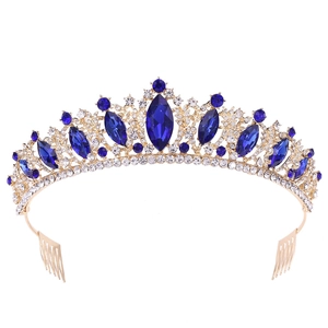 Close-up of golden bridal tiara with blue gemstones and sparkling rhinestones