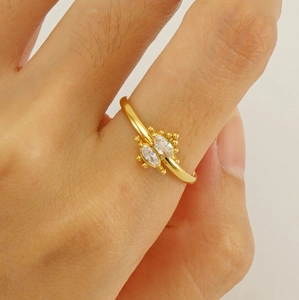 Detail of gold-plated ring featuring two marquise zircons and fine gold bead accents