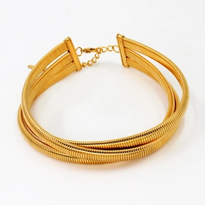 Detail of three-layer gold snake bone choker with ribbed texture and lobster clasp