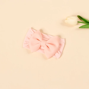 Detail of high-elastic soft nylon headband with large 3D bow for baby girls in pink