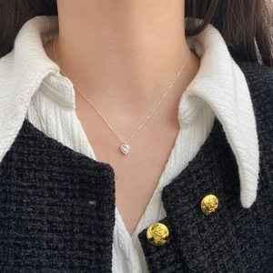 Close-up of S925 sterling silver heart necklace with zircon inlay on a model neck
