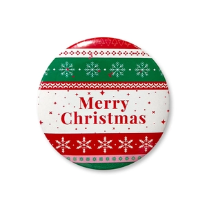 Detailed view of a 58mm Merry Christmas tinplate badge with festive stripes and snowflakes