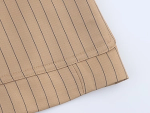Macro shot of khaki striped linen fabric texture with reinforced double-stitch detailing