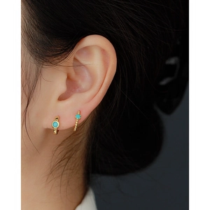 Elegant gold S925 silver hoop earrings with round turquoise stone on a female model
