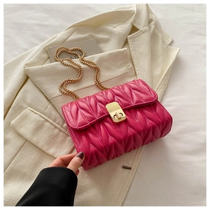 Close-up of pink pleated leather crossbody bag with V-quilt pattern and gold chain