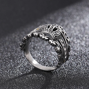 Detailed macro shot of vintage punk crown ring with zircon stones on black background