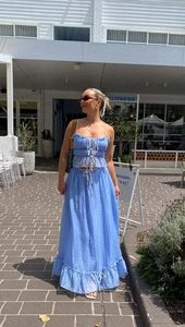 Detail of light blue pleated fabric with ruffle hem and drawstring on summer two-piece set