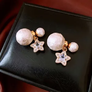 Elegant 18K gold plated pearl star earrings with sparkling crystals on silk background