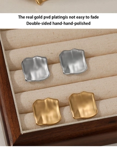 Macro detail of PVD plated hammered square studs in gold and silver finish