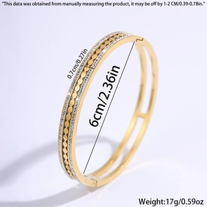 Gold plated stainless steel starry open bangle with pavé crystals and embossed patterns
