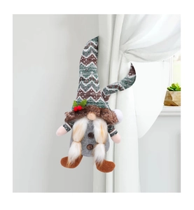 Macro detail of gnome curtain buckle with knitted hat and plush beard for Xmas decor