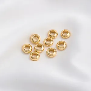 Macro view of polished 14K gold-filled large hole spacer beads for DIY jewelry making