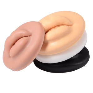 Macro shot of 3D silicone lip models in four skin tones for piercing and tattoo practice