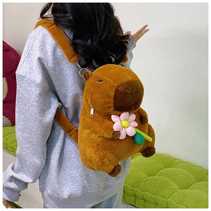 Detail of Capybara plush backpack with pink flower and adjustable brown straps