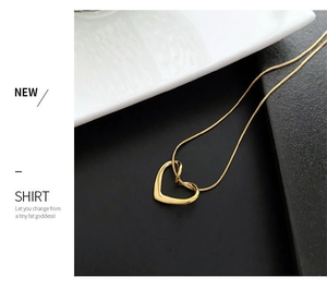 Detailed view of a gold hollow heart pendant necklace with a sleek snake chain design