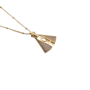Close-up of gold-plated Virgin Mary pendant with cubic zirconia crown and cross details